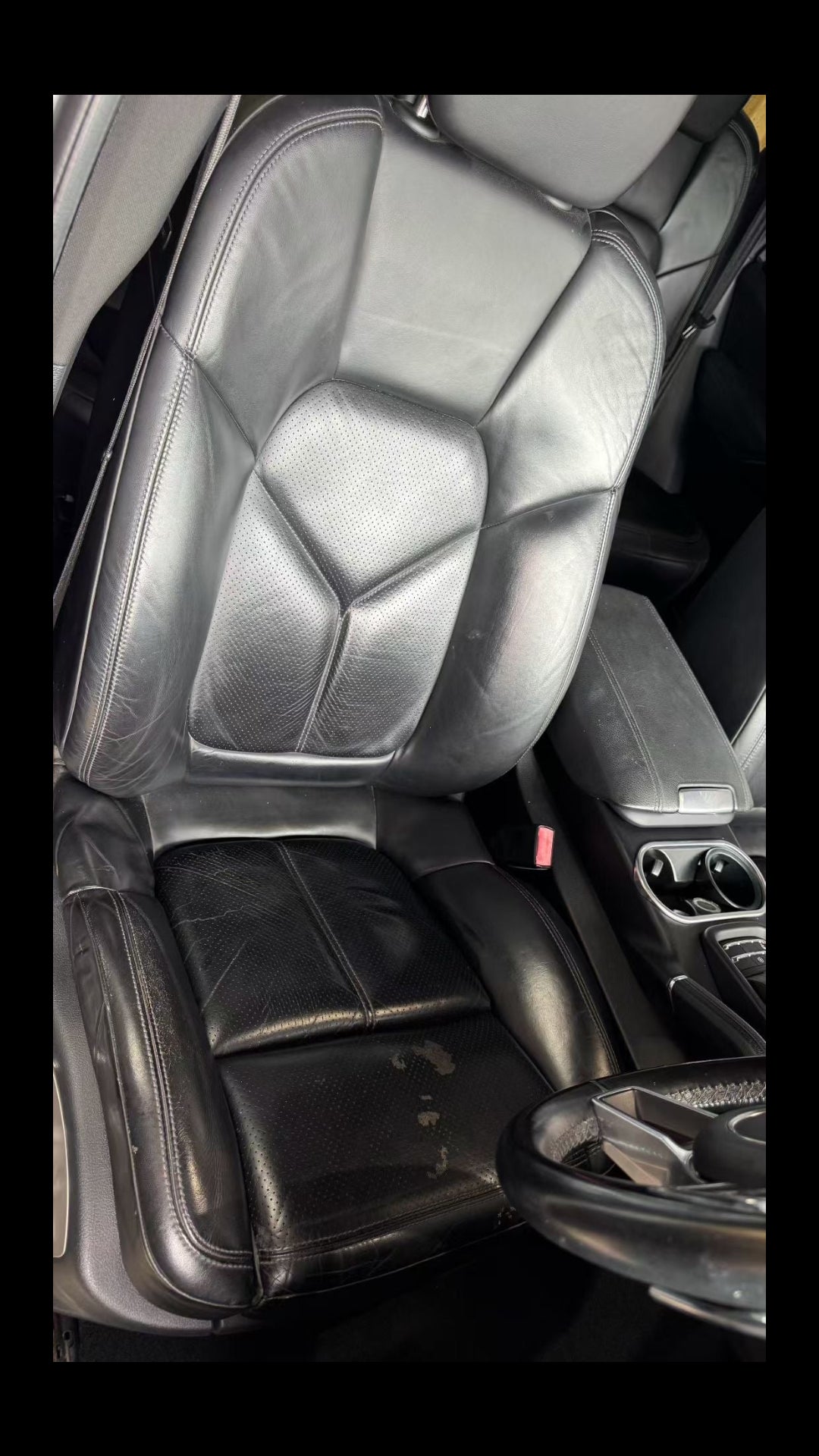 Worn Porsche driver seat with surface wear and creases before repair in Sydney